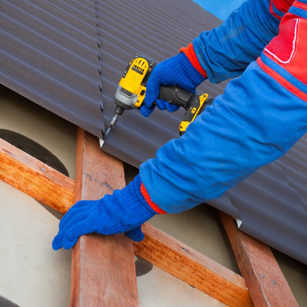 Man worker uses a power drill